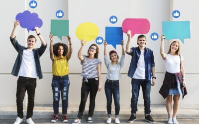 Young adults holding colorful speech bubbles